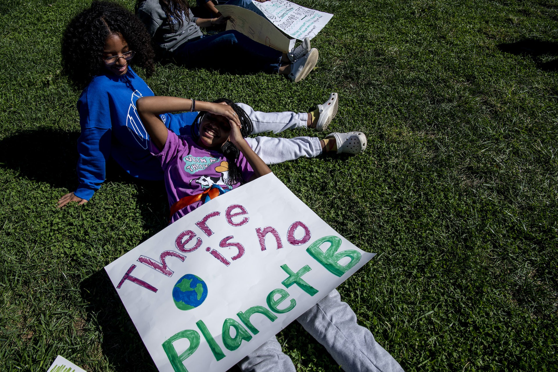 Two girls seen with a sign 'There is no Planet B.'